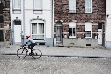 Woman cycling up hill